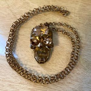 Somebody needs this gold color crystal brained scull necklace with sparkly eyes.
